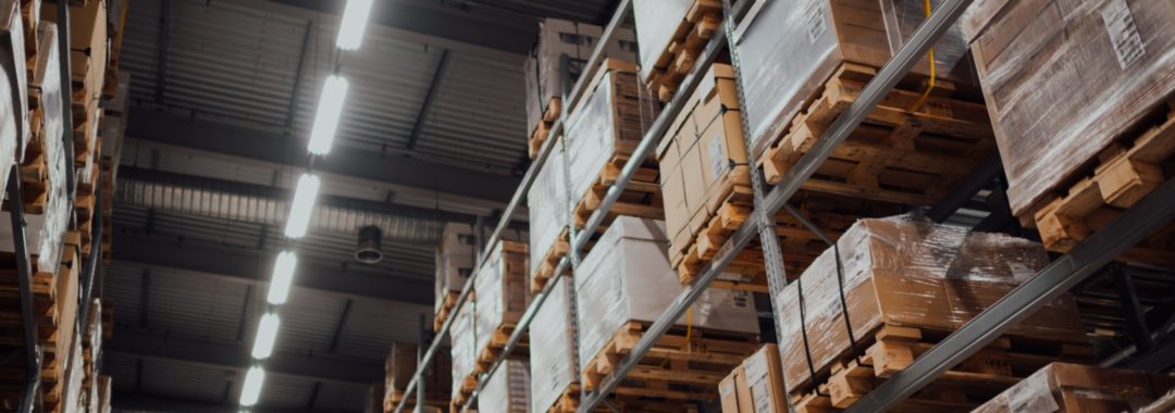 An ecommerce warehouse storage setting with pallets of boxes on racking